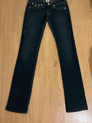 Blåa True Religion Billy Bootcut Jeans W27 - Fina True Religion Jeans i Blå färg. Jeansen är i mycket bra skick och sparsamt använda. |  Äkta som allt annat jag säljer! ✅ |  Storlek: W27 | Skick: Nyskick Färg: Blå | Märke: True Religion | Modell: Jeans |  Hör gärna av dig vid frågor så svarar jag så fort jag kan! 😁|  