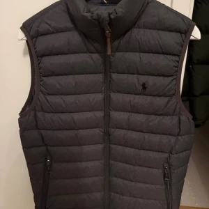 Grå dunväst från Polo Ralph Lauren - THE COLDEN PACKABLE DOWN VÄST  Ordinarie pris: 3 599:- 