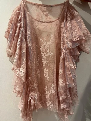 Rosa volangblus i spets - Fin genomskinlig rosa topp med fladdrande armar passar storlek xs och s och kanske m 