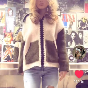 Rosa och olivgrön stickad kofta med dragkedja - Säljer en oversized stickad kofta i beige och olivgrönt med dragkedja framtill och stora fickor. Koftan har långa ärmar och kontrastfärgade detaljer längs dragkedjan. Perfekt för lager-på-lager och chill stil.