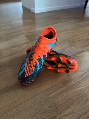 Adidas X Speedportal League Messi FG/MG | Strl 39 1/3 - adidas X Speedportal League Messi FG/MG fotbollsskor i färgen Team Solar Orange / Mint Rush / Core Black.  👟 Storlek: EU 39 1/3 (US 6.5 / UK 6) 🏷️ Modell: X Speedportal League Messi FG/MG ⚽ Passar för naturgräs och konstgräs  Skorna är använda och har synligt slitage från spel och träning, vilket framgår av bilderna. Trots detta är de fortfarande fullt spelbara och perfekta för träning eller match.  💬 Hör gärna av dig om du har några frågor!