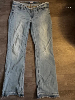 ”No waist” bootcut jeans  - Säljer ett par ljusblå bootcut jeans med låg midja från Nelly. Dom har varit insydda därav är hällan flyttad lite åt vänster men det insydda är borta och inget syns nu. Aldrig använda då dom va för stora. Nypris: 599 