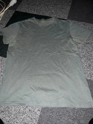 Grön basic t-shirt från Dressmann - Enkel grön t-shirt från Dressmann med klassisk passform och rund hals. Tillverkad i mjuk bomull som känns skön mot huden. Perfekt till jeans eller shorts för en avslappnad look. Står L men skulle säga att det är mer M