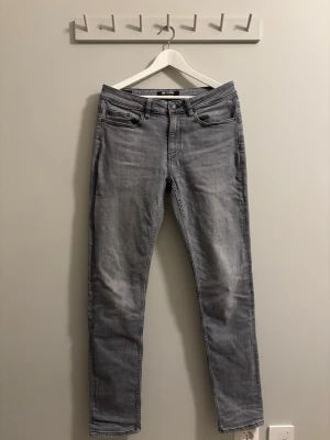 Grå regular jeans från ONLY & SONS - Snygga grå regular jeans från ONLY @ SONS med klassisk femficksdesign och normalhög midja. Jeansen har en tvättad look och raka ben. Tillverkade i mjukt denimtyg som ger en bekväm känsla och stilren vibe. Sparsamt använda passar bra till kille 180 lång. Pris kan diskuteras 