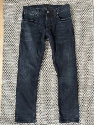 Nudie Jeans (Grim Tim) - Säljer nu dessa riktigt snygga Nudie jeans i den populära modellen Grim Tim🤩💯Storleken är W31 L30 och är mycket bekväma och passar till allt🙌🤩Jeansen är i väldigt bra skick och är väl omhändertagna😁💯Vid frågor och funderingar är det bara att skriva✍️📝