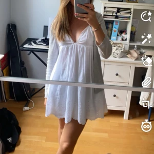 Vit kort klänning med v-ringning - Söt vit kort klänning med djup v-ringning, säljer då den börjar bli lite kort för mig