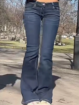 Mörkblå bootcut jeans med kontrastsömmar - Säljer ett par mörkblå bootcut jeans med vita kontrastsömmar och låg midja. Jeansen har klassisk femficksdesign och vida ben som ger en retrovibe. Perfekta för dig som gillar en trendig och avslappnad stil.