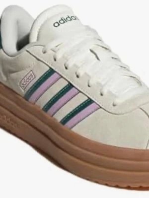 Adidas sneakers med pastellränder 38 - Snygga Adidas sneakers i vitt med klassiska tre ränder i lila och grönt på sidan. Skon har en tjock gummisula i brunt och ovandel i mockaliknande material. Perfekt för dig som gillar retrostil och vill sticka ut med färgdetaljer.