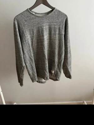 Grå basic sweatshirt - Enkel och stilren grå sweatshirt med rund hals och långa ärmar. Tröjan har en avslappnad passform och är tillverkad i mjukt material, perfekt för en casual look. Passar till det mesta och är lätt att matcha med andra plagg.