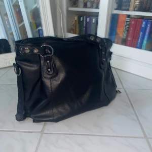 Säljer denna superfina svarta väskan då den ej kommer till användning. Perfekt som skol- och jobbväska! Fint skick! Eventuellt äkta läder men är ej säker pga saknande av lapp. Samma gällande märke - vet ej pga saknade av lapp.