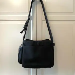 Late 90’s/early 00’s Miu Miu messenger bag. Cond: good condition for its age. The material on the back of the bag has begun to fray a little in one spot from years of rubbing against the body (pictures sent at request), otherwise in great condition.