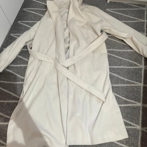 Kappa - Säljer en lång vit/beige kappa som är ganska tjocka kan användas i vinter,köpte den för 1000 i H&M 