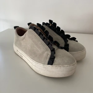 K. Cobler Sneakers Volang - Grå sneakers med svart volang ifrån K. Cobler. Använda vid endast två tilfällen. Storlek 36. 