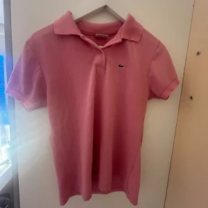 Rosa piké från Lacoste - Rosa superfin piké från Lacoste💘 Vintage och i bra skick🫶🏼 använd 3-4 gång, säljer för att den inte används💕 Pris kan diskuteras❣️