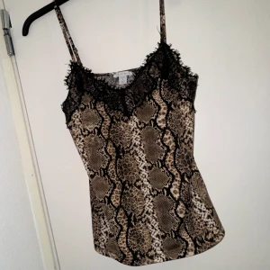 Mönstrat linne med spets - Snyggt mönstrat linne med svart spets, storlek S men passar M/L beroende på kroppsform o hur man vill den sitter🎀säljer ett likadant i storlek M fast med annat mönster🌸🎀✨Handla gärna med bundle o få med extra gåvor❤️🛍️🎁🫶🏼