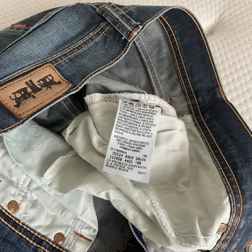 Vintage Levis 524 jeans. Storlek w28 l36. Låg midja och lätt utsvängda ben, typiska 2000-talsjeans. ”Vaxad” yta. Midjemåttet rakt över är 37-38 cm cm och innerbensmåttet är ungefär 89 cm. Gylfen åker ner men jag har löst det men en liten ring, bild 5. Jeans & Byxor.