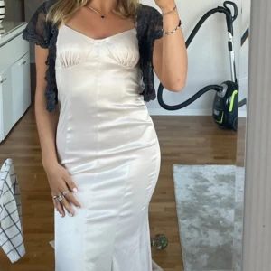 Satinklänning  - Superfin crémefärgad och figursydd satinklänning med slits där bak. Endast använd en gång!
