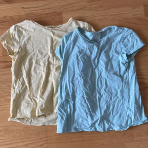 Två tshirts  - En ljus gul t-shirt och en ljus blå/grön t-shirt  Båda i bra skick 