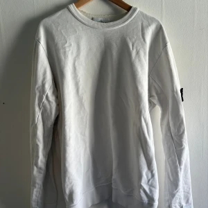 Stone Island Tröja - Säljer nu denna sweatshirt från  Stone Island, den vita färgen är sjukt fin till våren & sommaren, cond 9/10. Badgen tillkommer.  Hör av dig vid intresse och för fler bilder🌟