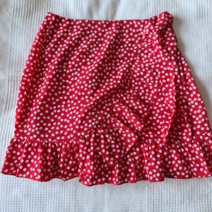 Röd mönstrad kjol  - Jättegullig röd kjol med vita blommor. 