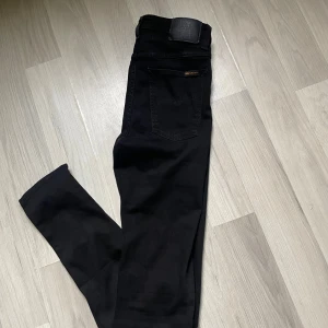 Svarta jeans från Nudie Jeans Co - Säljer ett par svarta jeans från Nudie Jeans Co i modellen W29 L34. Snygg, smal passform och tillverkade i mjukt bomullstyg med stretch.                W29 L34.                                                                          Skriv vid frågor✅