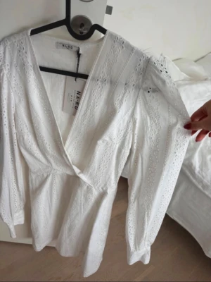 Klänning NA-KD - Så vacker klänning från NAKD som jag tänkte ha till studenten men hittade en annan! Aldrig använd och så fin till sommaren! V-ringad och broderingar. Skulle säga att den passar upp till S! Nypris: 650kr