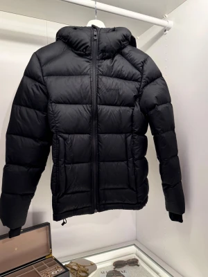 Svart pufferjacka från Everest - Säljer en svart pufferjacka från Everest med huva och dragkedja framtill, varm och skön. Hör av dig om du vill se hur den sitter på! Pris kan diskuteras.