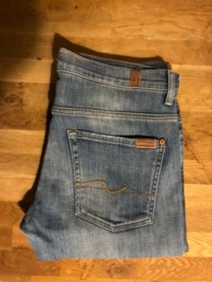 Blå raka jeans från Nudie Jeans - Säljer ett par klassiska blå jeans från Nudie Jeans med raka ben och normal passform. Gammal model av nudie 