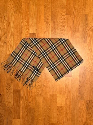Beige Burberry halsduk - Säljer en beige halsduk från Burberry. Halsduken är gjord i lamull och är i gott skick. Var inte rädd för frågor. Pris diskuteras inte!