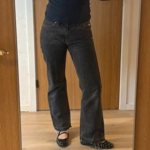 Svarta bootcut jeans med rå kant - Snygga svarta jeans med bootcut-modell och rå, fransad kant nertill. Jeansen har klassisk femficksdesign och normal passform. Perfekta för dig som gillar en avslappnad men trendig stil.