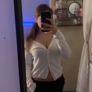 Vit kofta med v-ringning och knappar - Säljer en vit kofta.