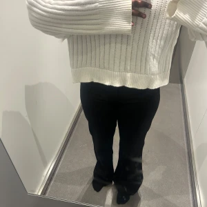 Vit stickad tröja från C, XL - Säljer en vit stickad tröja från C i storlek XL. Tröjan har ett snyggt ribbat mönster, långa ärmar och breda muddar. Perfekt för lager-på-lager och chill vibes. Passformen är lite loose och den är supermjuk och skön.