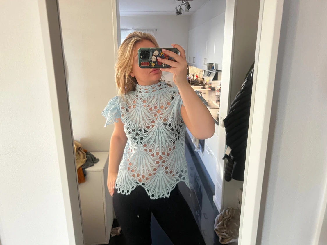 Ljusblå spetsblus med volang