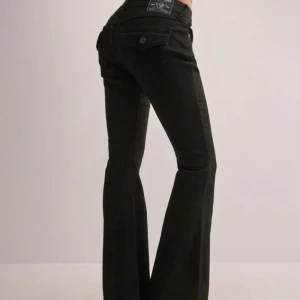 Svarta bootcut jeans från True Religion - Svarta jeans från True Religion med bootcut passform och klassiska detaljer. Byxorna har låg midja, snygga bakfickor med lock och knapp samt diskret logga. Tillverkade i stretchig bomullsdenim för en bekväm känsla och snygg siluett.