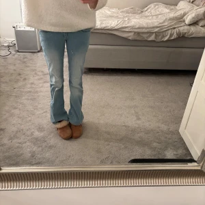 Ljusblå bootcut jeans - Ljusblå bootcut jeans med svarta detaljer ibak på fickorna. Säljer pga att de är för små