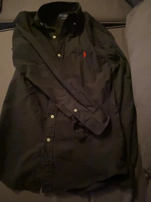 Svart slim fit skjorta från Ralph Lauren - Svart skjorta från Ralph Lauren i slim fit, storlek s, använt sparsamt, kontakta mig om ni har några funderingar