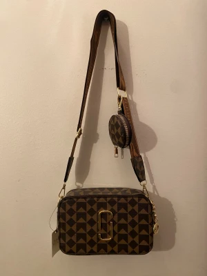 Brun geometrisk axelväska Jingpindaishu - Helt ny väska oanvänd lägger bara i min garderob så tänkte sälja den så nån snygg personer kan ha på sig den oanvänd mitt pris är 600 min Max är 500-550 men snabb betalning så kan jag sänkas!!! Skriv för flara frågar Annas äre bara o trycka på köp❤️