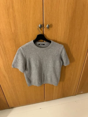 Grå stickad kortärmad tröja - Säljer en gullig grå stickad kortärmad tröja från Gina tricot i storlek S. Skriv gärna vid funderingar. 