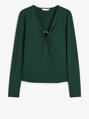  Skitsnygg Mörkgrön festtopp med ringdetalj - 💚Snygg mörkgrön långärmad topp från H&M med v-ringning och en cool ringdetalj framtill som hålls ihop av två små silvriga nitar. Toppen är figurnära och gjord i mjukt, stretchigt syntetmaterial. Nypris 350 och är slutsåld överallt säljer för 150 då den har tre små revor på baksidan men dem märks inte alls när man har på sig plagget!☺️