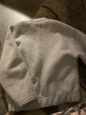 Grå teddyjacka från Zara XS - Säljer en grå teddyjacka från Zara i storlek XS. Jackan har en mjuk och fluffig yta, dragkedja framtill och två fickor. Perfekt för dig som gillar chill och cozy vibes. Enkel design med rundad hals och långärmad modell.