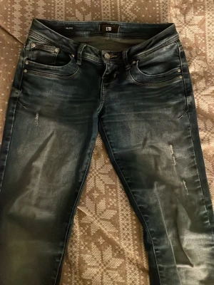 Mörkblå bootcut jeans från LTB - Säljer ett par mörkblå bootcut jeans från LTB med slitna detaljer och snygg tvätt. Jeansen har låg midja och stretchigt material för skön passform. Köpte dom för ca 900kr på zalando. Pris kan diskuteras!💕