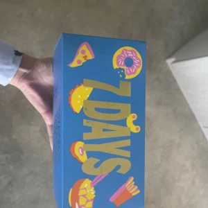 Färgglada Happy Socks 7 Days box - Säljer en limited edition 7 Days box från Happy Socks med fyra par strumpor i olika färger och roliga matmönster som pizza, sushi och hamburgare. Perfekt för dig som vill ha lite extra färg och humor i din stil. Strumporna är i mjuk bomull och har coola, unika prints. Storlek 43-46