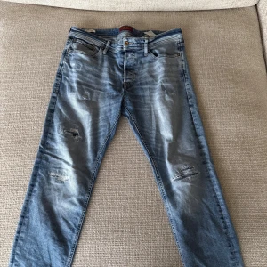 Blå slitna jeans med en bra slim pass form - Snygga blå jeans med slitningar och ljusa tvättade partier. Slimade ben och klassisk femficksmodell. Jeansen har en Slim passform och är tillverkade i jeansmaterial. Perfekta för en avslappnad och trendig look.