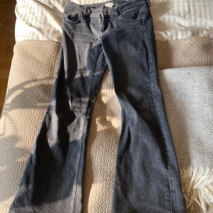 Bootcut jeans från Gina Tricot - Snygga bootcut jeans från Gina Tricot i storlek 158. Jeansen har klassisk femficksdesign, dubbla knappar i midjan och är tillverkade i mjukt denimtyg. Perfekta för dig som gillar en retroinspirerad look med utsvängda ben.