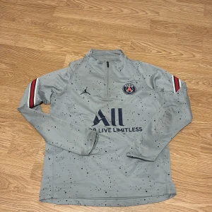 Psg tröja - Säljer en snygg grå PSG fotbollströja från Jordan med lång ärm och halv dragkedja. Det är storlek XS och har bra kvalité. Hör av er vid intresse!