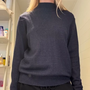 Mörkblå stickad tröja  - Mörkblå stickad tröja i ett tjockare material. Ribb vid nacke, midja och ärm. På lappen står det att den är i storlek XL men sitter som S eller M. 