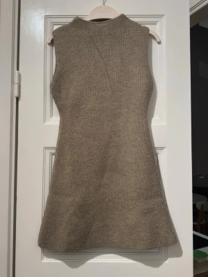 Knitted dress from H&M in S size  - Used once for photoshoot for few hours.  Beige color knitted dress from H&M in S size  Fabric is thick, knitted and alighted stretchable.  Original cost is 349kr.  Note: size tag has been removed has it was itching the model. Hence the price 