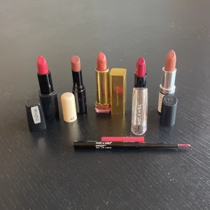 Mix av läppstift och läppenna - Säljer ett kit med fem läppstift i olika nyanser som rosa, nude och rött från Isadora, H&M, Max Factor och Wet n Wild samt en matchande rosa läppenna från Wet n Wild. Perfekt för dig som vill variera din look med både matta och glansiga finishar.2stycken aldrig använda 