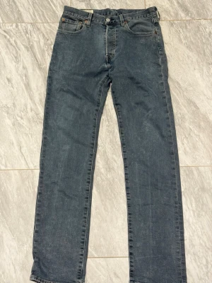 Levi's raka blå jeans - Klassiska blå jeans från Levi's med rak passform och fem fickor. Jeansen har en diskret tvättad look och är tillverkade i denim. Perfekta för en avslappnad stil och passar till det mesta.