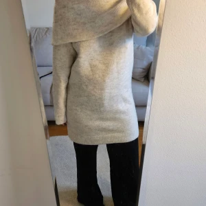 Beige stickad klänning från Cubus - Mysig cremefärgad/ljust beige stickad klänning från Cubus med bred krage som kan bäras offshoulder. Långärmad och rak modell i mjukt och härligt material. 